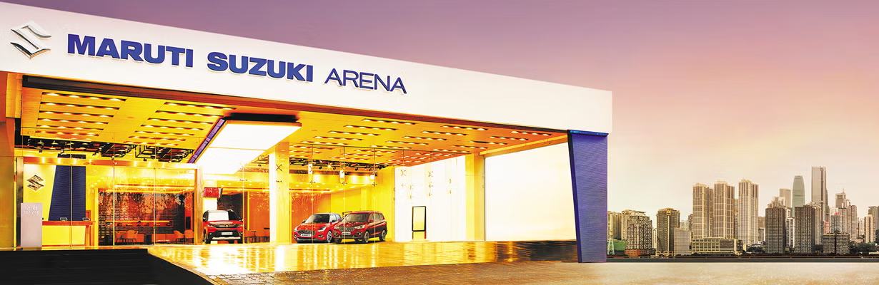 The Maruti Suzuki ARENA showroom frontage at dusk
