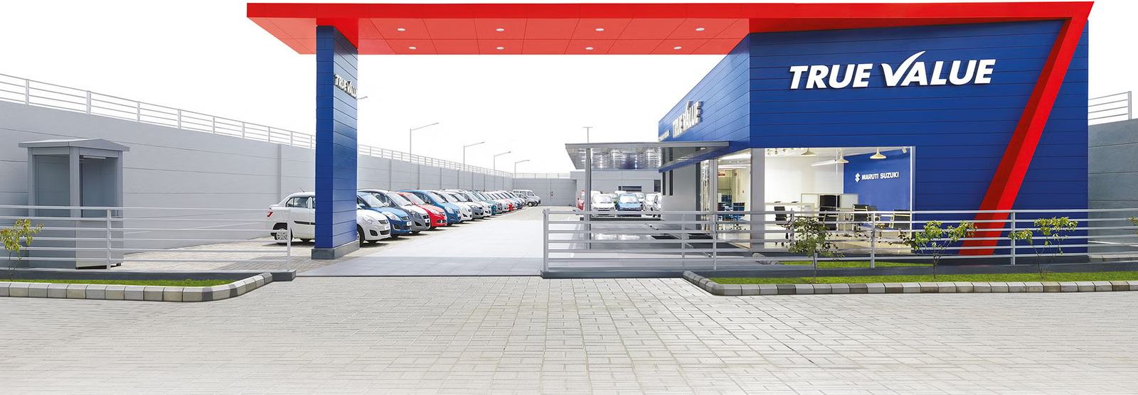 Rows of certified pre-owned cars at a Maruti Suzuki True Value outlet