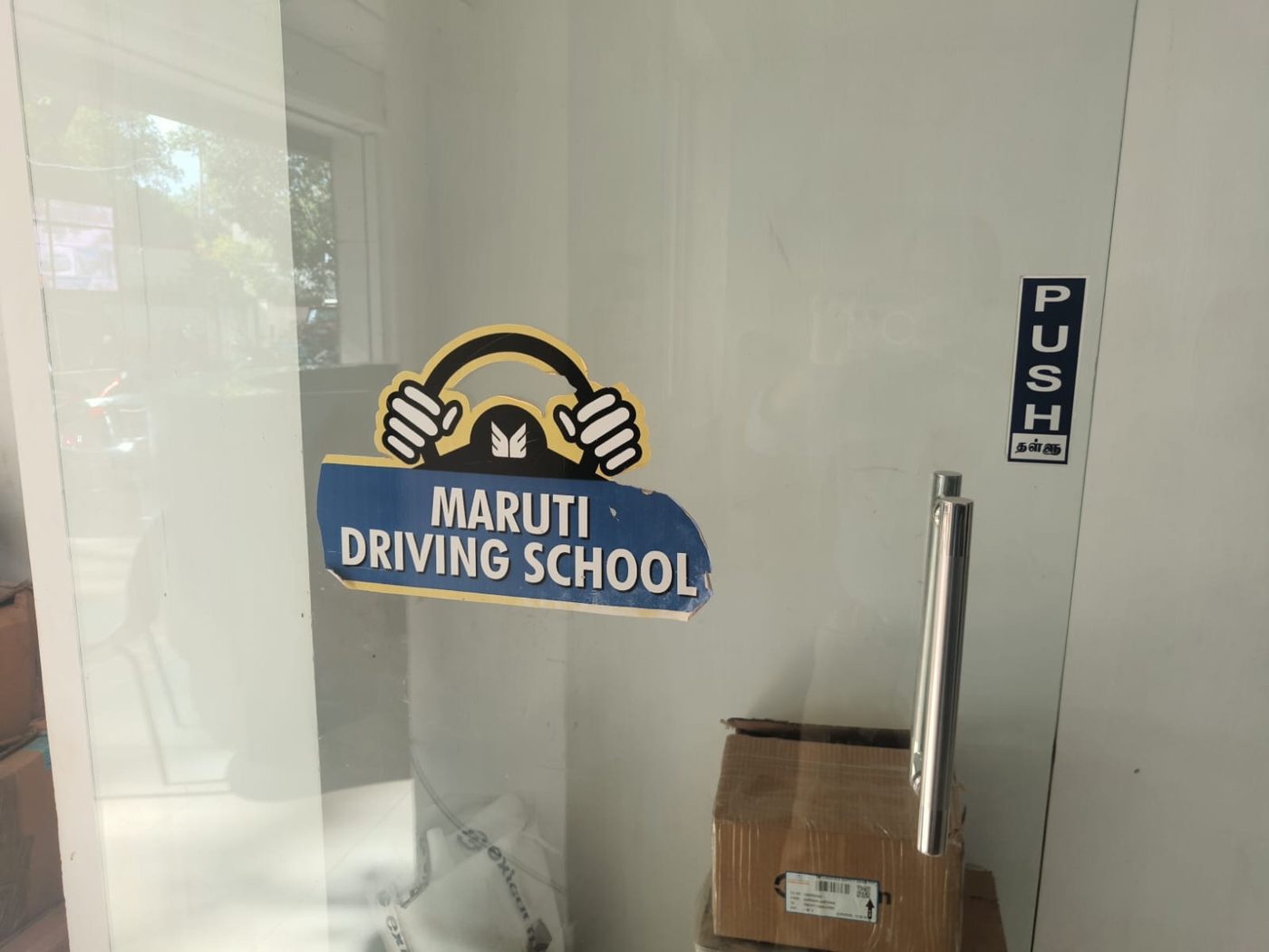 Maruti Driving School logo on the glass entrance door