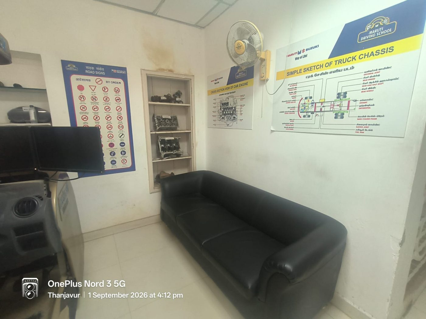 Training room with seating, road sign charts and cut-section engine components on display
